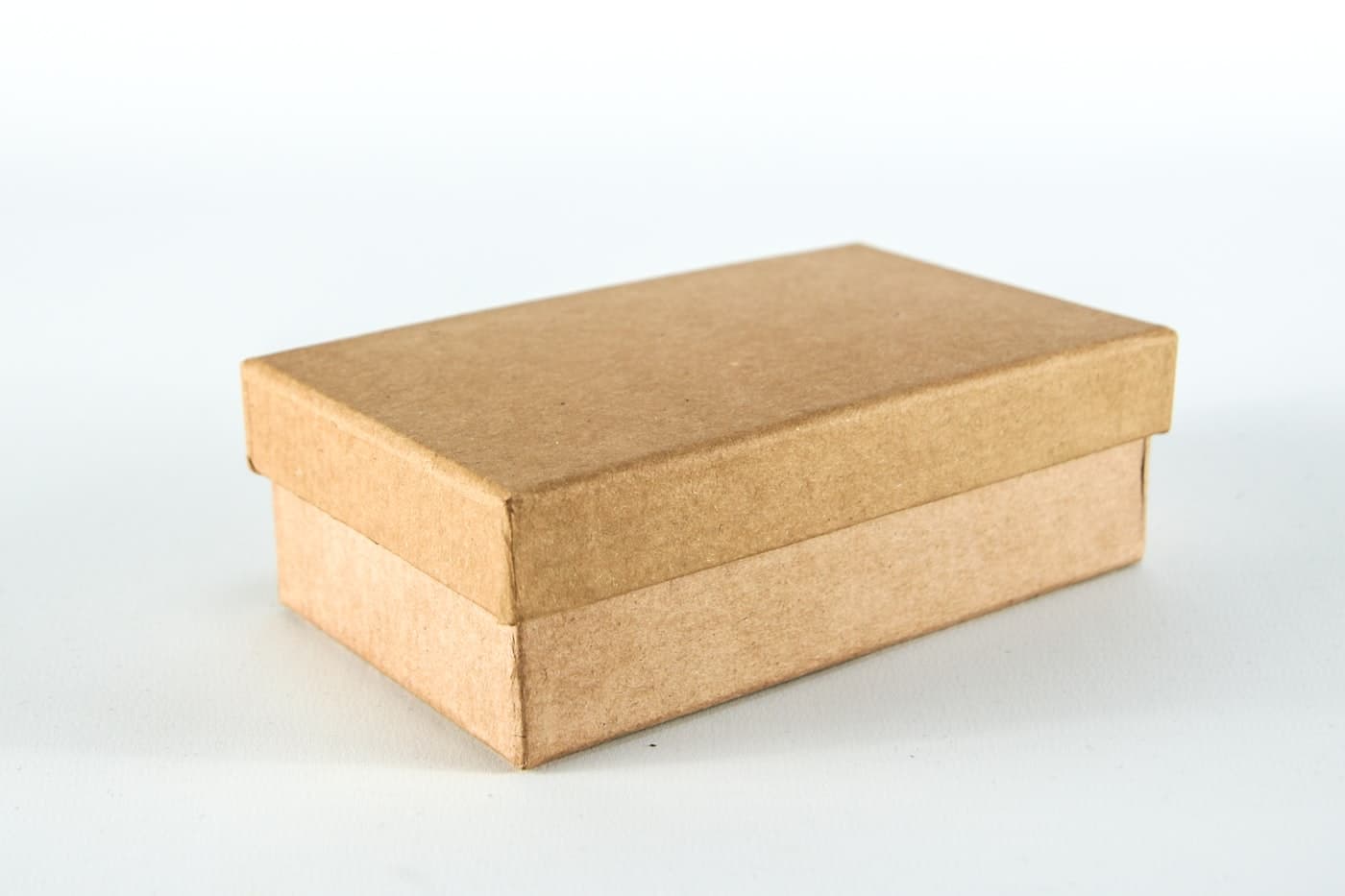A small brown single-wall corrugated carton