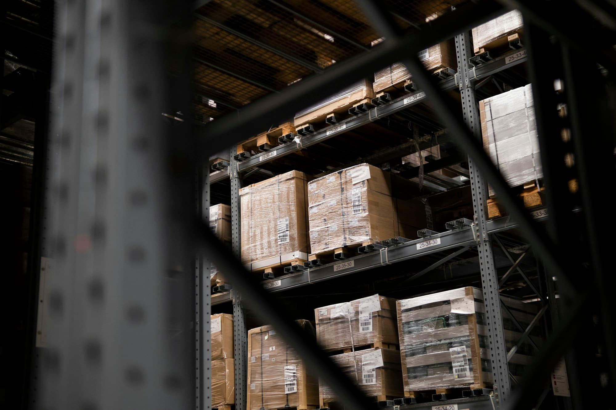 Corrugated shipping cartons stacked on a pallet in a distribution warehouse